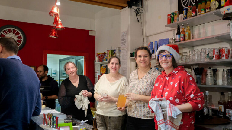 Équipe de bénévoles souriants en service dans un lieu associatif à Andouillé-Neuville